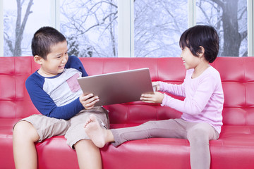 Two kids fighting to take over laptop