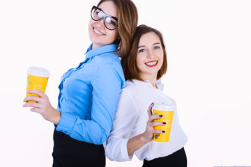Businesswomen standing back to back with cup of coffee on their break