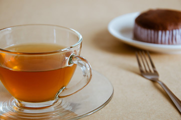 Glass Cup of Tea and Chocolate Cake for Tea Break.