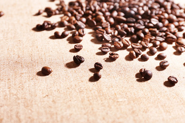 Roasted coffee beans on the linen fabric