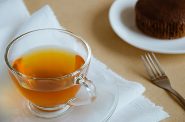 Glass Cup of Tea and Chocolate Cake for Tea Break.