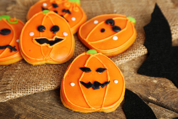 Creative cookies for Halloween party on wooden table, close up