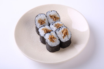 Deep Fried Salmon skin maki sushi on ceramic dish isolated on wh