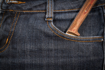 Old knife with a wooden handle in your pocket jeans.