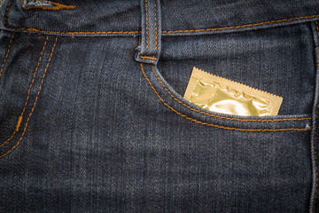 Condom in jeans pocket.  background. - obrazy, fototapety, plakaty