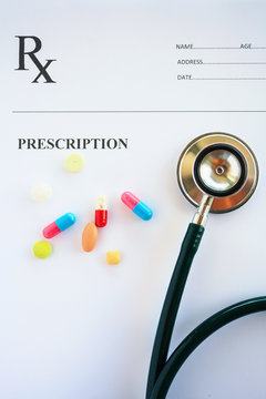 Pills and stethoscope on a prescription