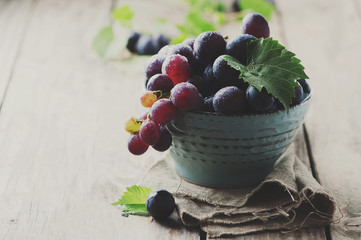 Red sweet grape on the wooden table