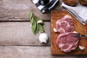 Marbled beef steak and spices on wooden background