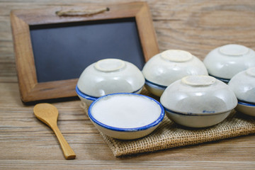 Thai dessert made of coconut milk on wood with balck board, Stea