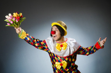 Clown with tulip flowers in funny concept