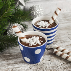 Chocolate pudding with cookies in ceramic vintage glasses on bright wooden surface