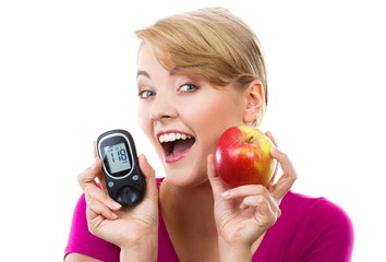 Happy woman holding glucometer and fresh apple, measuring and checking sugar level, concept of...