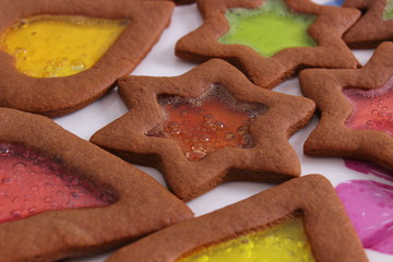 Stained glass gingerbread on old wooden background, christmas time
