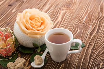 Tea cups with teapot on old wooden table