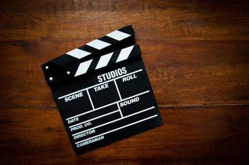 Naklejka premium Movie clapper board on wood