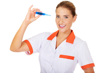 Young female doctor or nurse holding thermometer