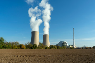 Fototapeta na wymiar Nuclear power plant on sky background in sunlight