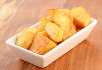chunks of chips in small porcelain bowl on wooden classic