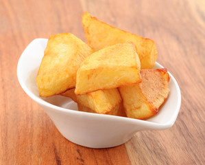 chunks of chips in small porcelain bowl on wooden classic
