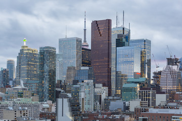 Toronto Financial District skyscrapers and the CN Tower apex on the background at sunset