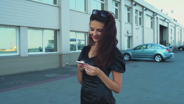 beautiful bisinesswoman uses a smartphone in the seaport slow motion
