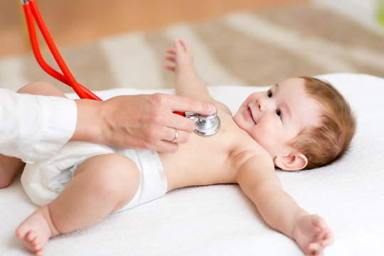 Baby having it's heartbeat checked by doctor pediatrist