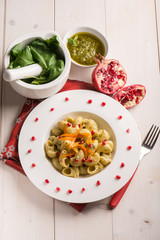 pasta with pesto pomegranate and sliced carrot