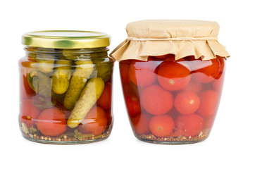 Glass jars with marinated tomatoes and cucumbers