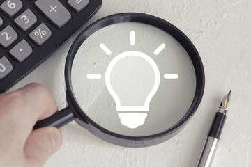 Businessman search loupe magnifier idea bulb button