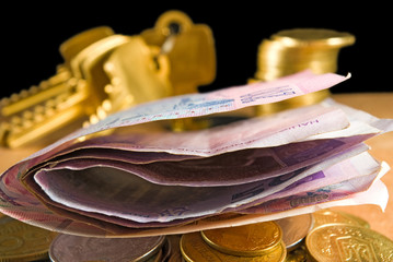 money coins, bills, keys on a black background