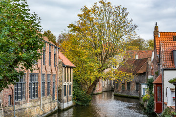 Fototapeta na wymiar Medieval houses over the canal in Bruges on a cloudy day