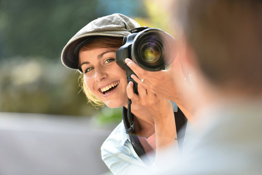 Young woman photographer doing a photoshoot with model