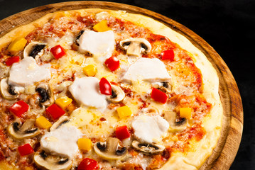pizza on the board with ham