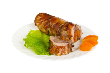 Roulade of wild boar with dried apricots on the plate, isolated