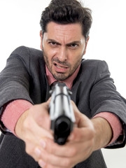 young attractive man pointing gun in aggressive and upset face e