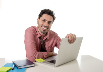  happy attractive businessman in shirt and tie at office desk working with computer smiling