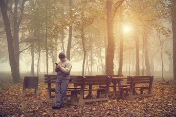 Man play in his mobile phone in the park