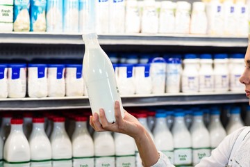 Beautiful woman holding milk bottle