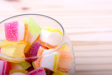 Colorful candy in jar on table