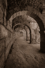 Internal passages in the ancient Roman amphitheater of Aspendos. The province of Antalya. Mediterranean coast of Turkey. Sepia. Toning. Stylization.