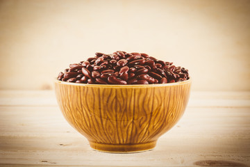 red  beans on wood background - soft focus with vintage film fil