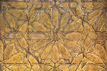 Intricate oriental golden pattern in Fes, Morocco.
