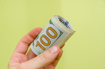 man hand holding money dollars isolated on green background