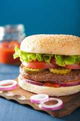 burger with beef patty lettuce onion tomato ketchup