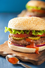 burger with beef patty lettuce onion tomato ketchup