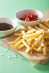 french fries with ketchup over green background