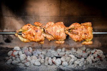 Cooking 3 rotisserie chicken on the grill with Charcoal and Briq