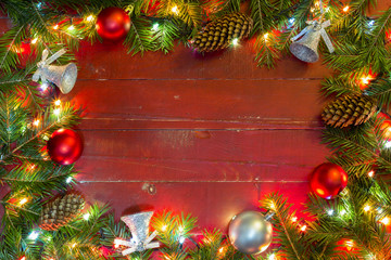 Christmas lights- Merry Christmas.

Christmas fir tree with decoration on a red wooden background.