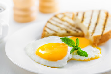 Fried eggs with toasts. Traditional food for breakfast.
