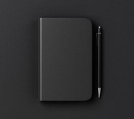 Blank black diary cover and pen on black table, mock up